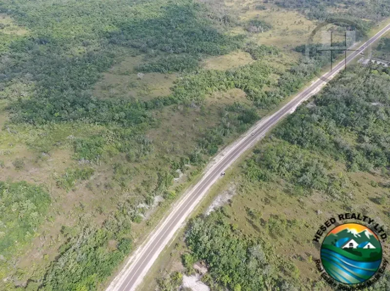 25-acre land in Carmelita with highway frontage, perfect for commercial development. Belize real estate.
