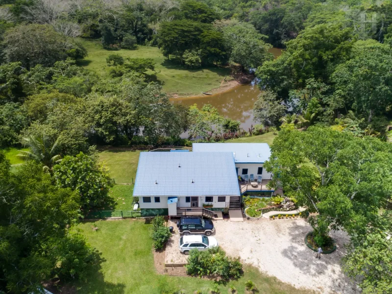 2.08 acre turnkey riverfront estate in Teakettle, Cayo District. Ideal Belize real estate investment with natural beauty and comfort.