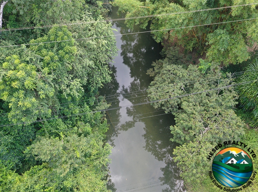 Serene view of a creek meandering through the 118-acre property, adding aesthetic and practical value.