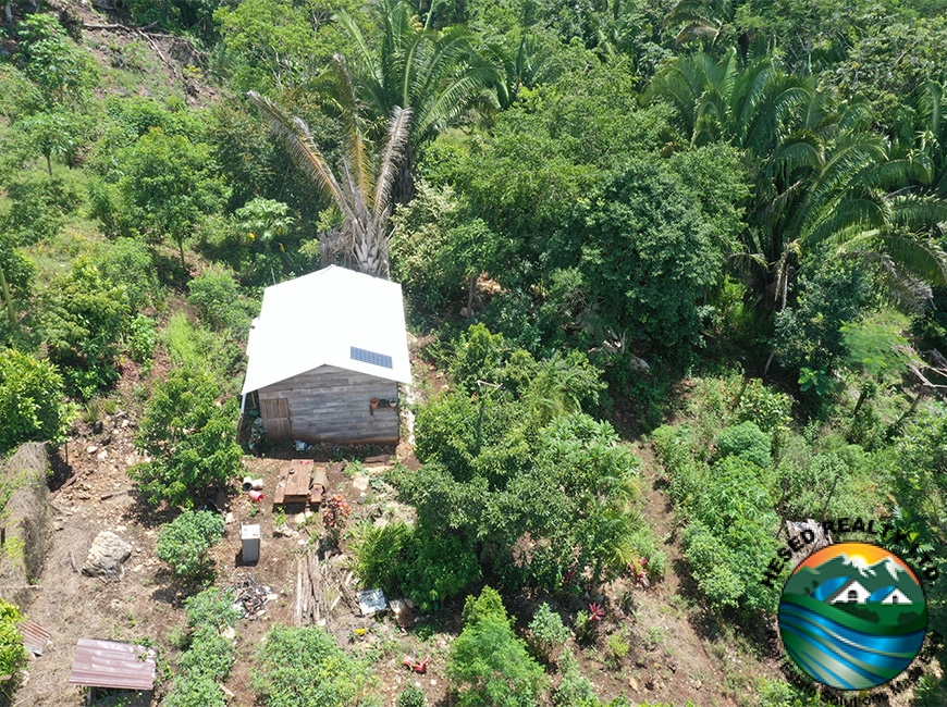 A drone photo showing the front of the storage house on a 3-acre property in Agua Viva.