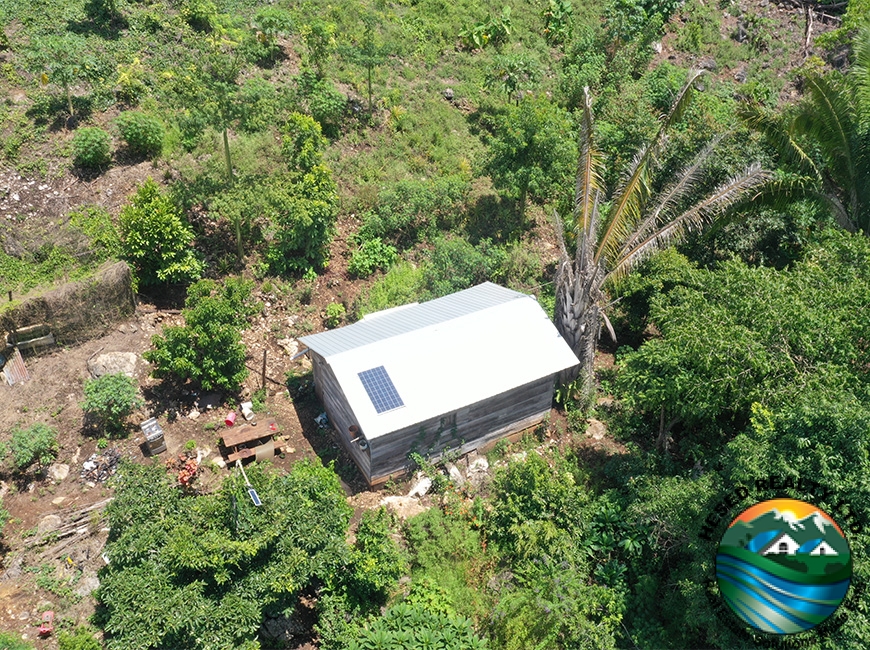 A drone photo of a storage house on the 3-acre property in Agua Viva, offering space for storage and further development.