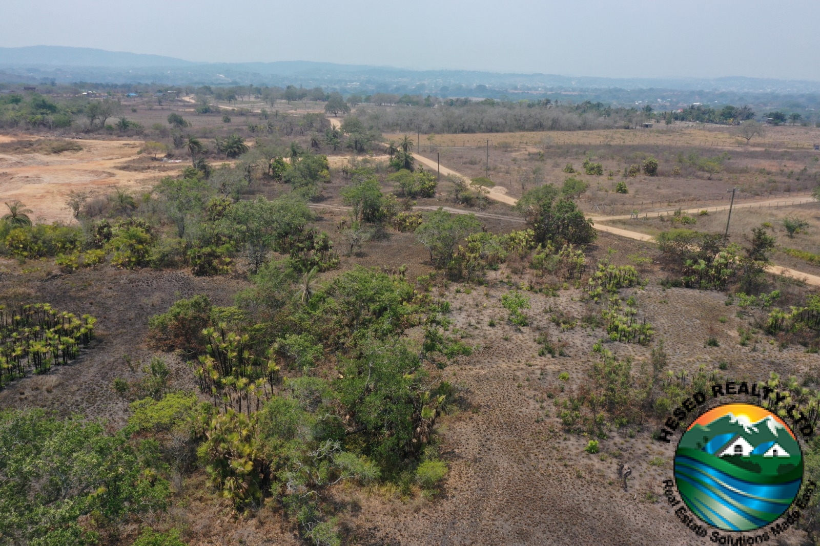 Ground view of a corner of the property with green trees in Billy White, Belize.