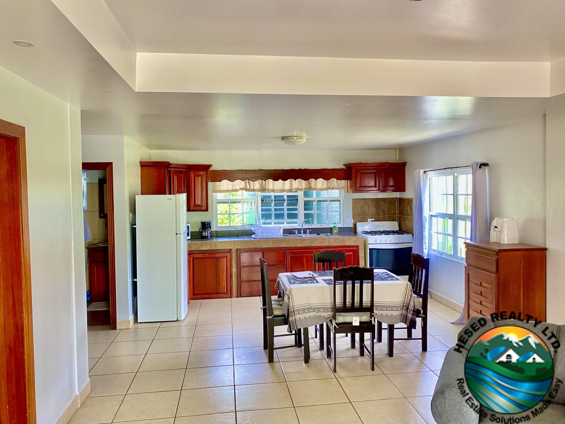 Modern kitchen in Belmopan apartment with updated appliances and plenty of storage space.