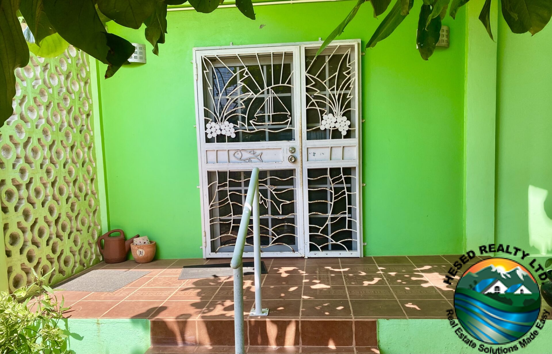 Burglar-barred door at the entrance of 1-bedroom apartment in Belmopan, ensuring security.