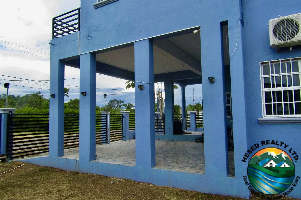 "Exterior view of a modern house with landscaped yard, large windows, and sleek architectural design."