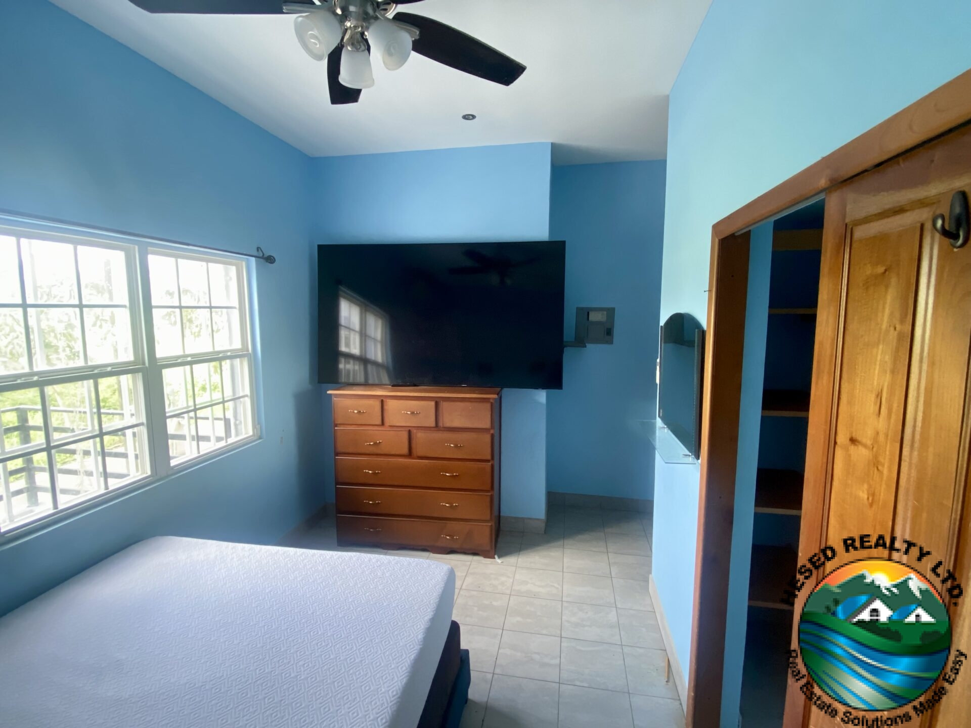 Well-lit bedroom on the first floor with tasteful decor and cozy atmosphere.