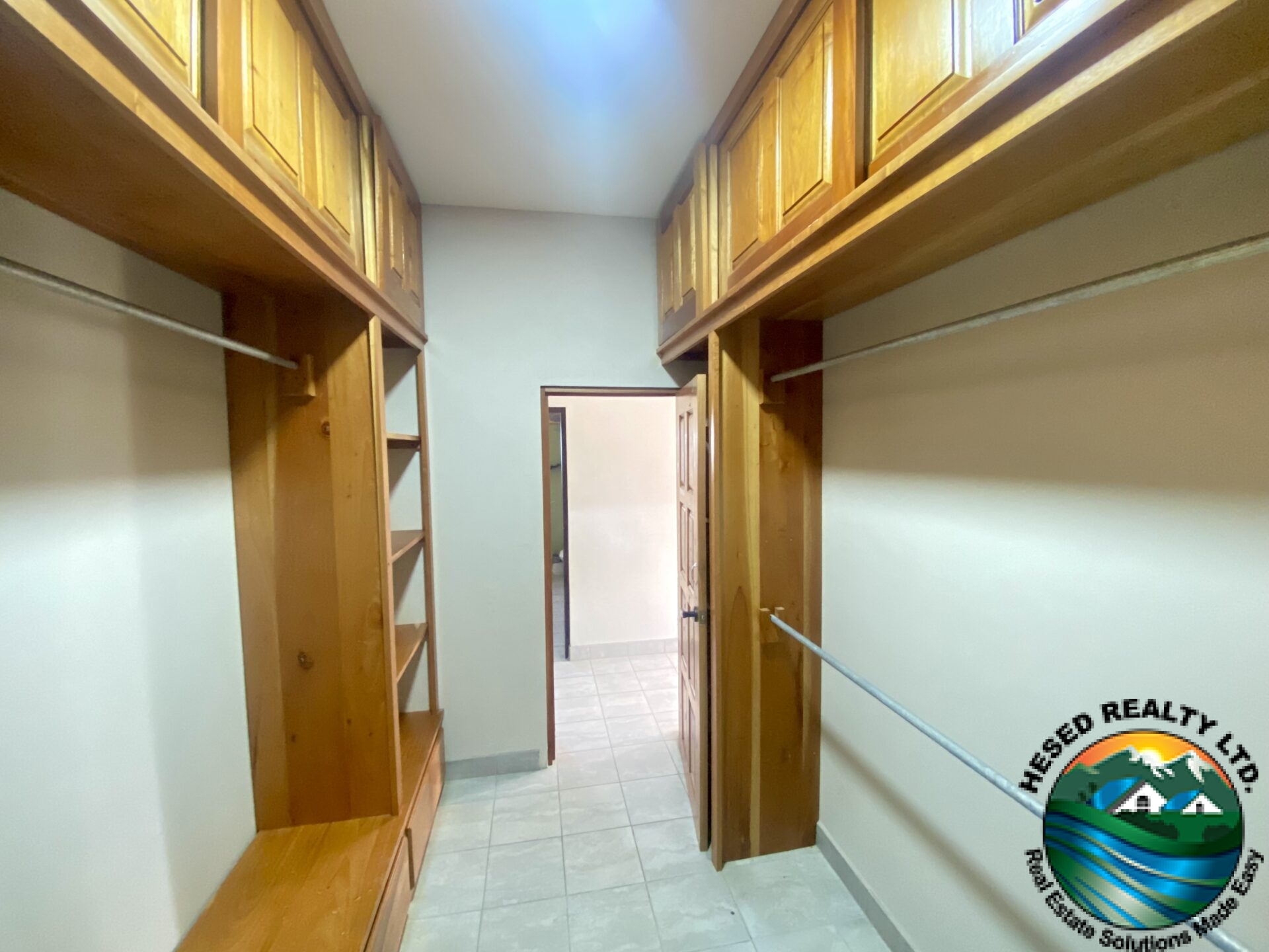 Spacious master bedroom walk-in closet with built-in shelving and ample storage space."