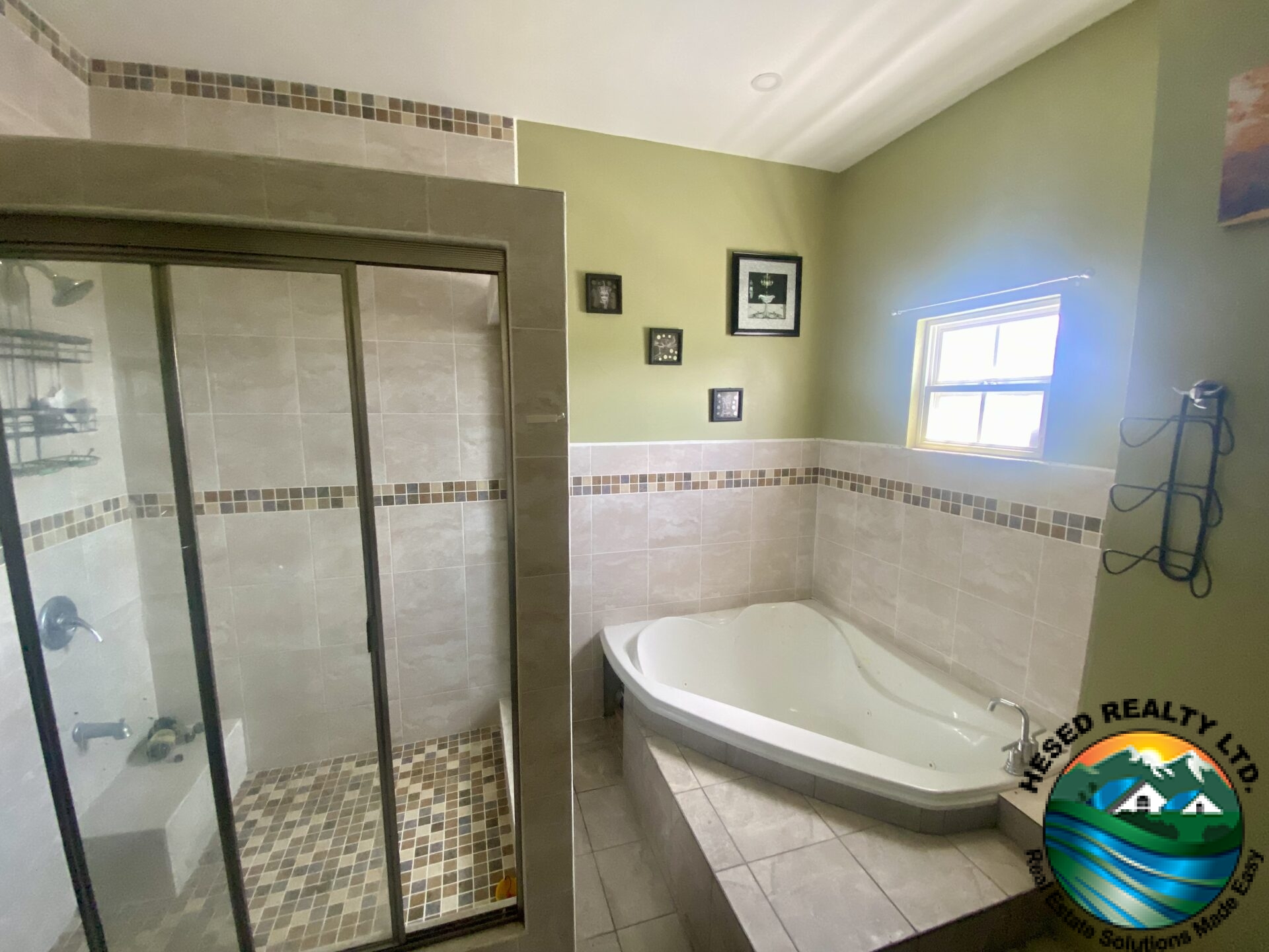 "Luxurious master bathroom with modern fixtures, sink, and a spacious walk-in shower."