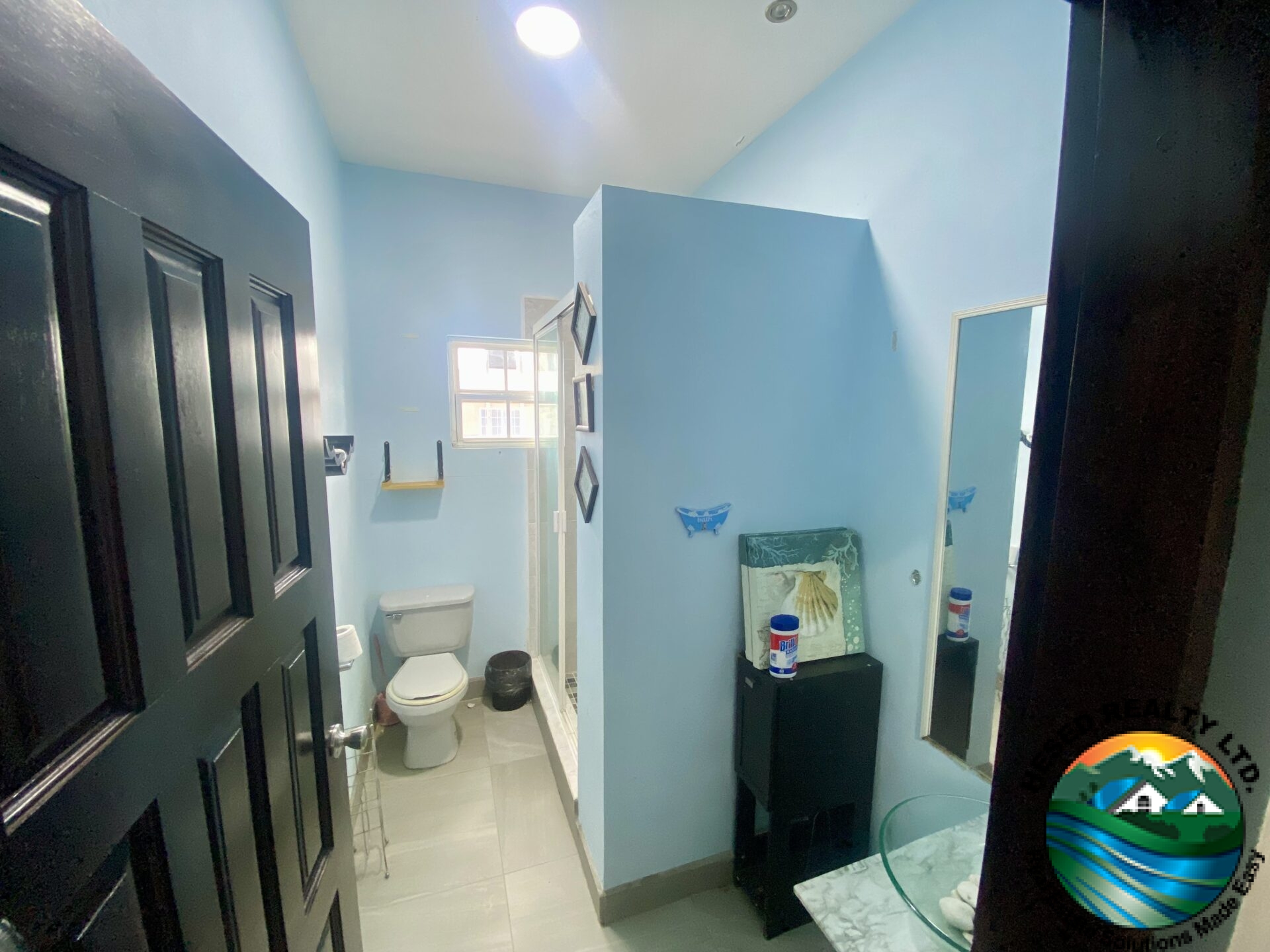 Ground floor bathroom with sleek fixtures, elegant sink, and modern lighting.