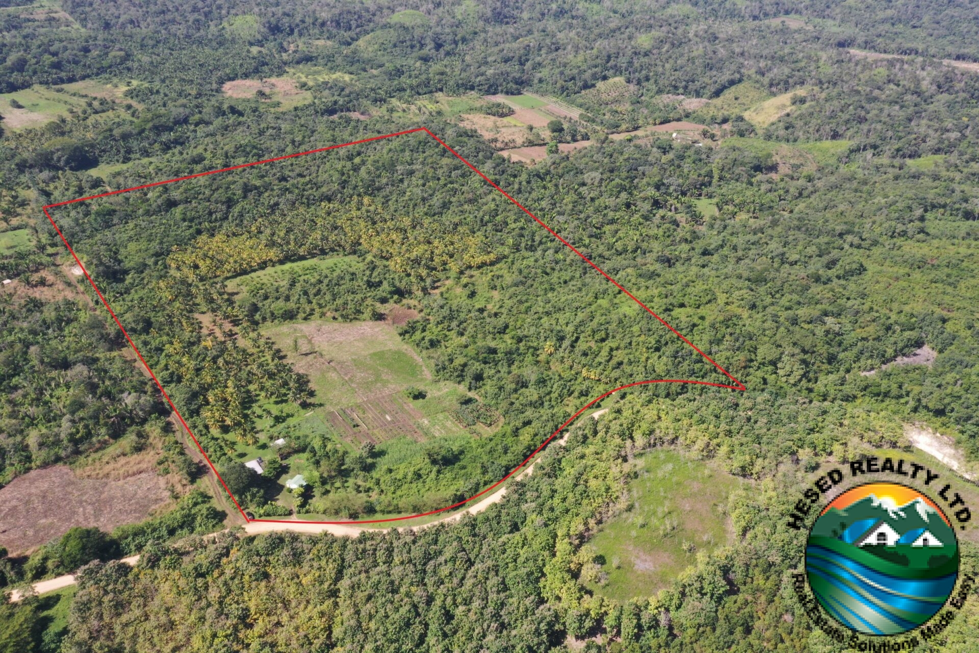 Drone photo of Teakettle Village property with boundaries marked in red, showcasing the expansive 30-acre land.