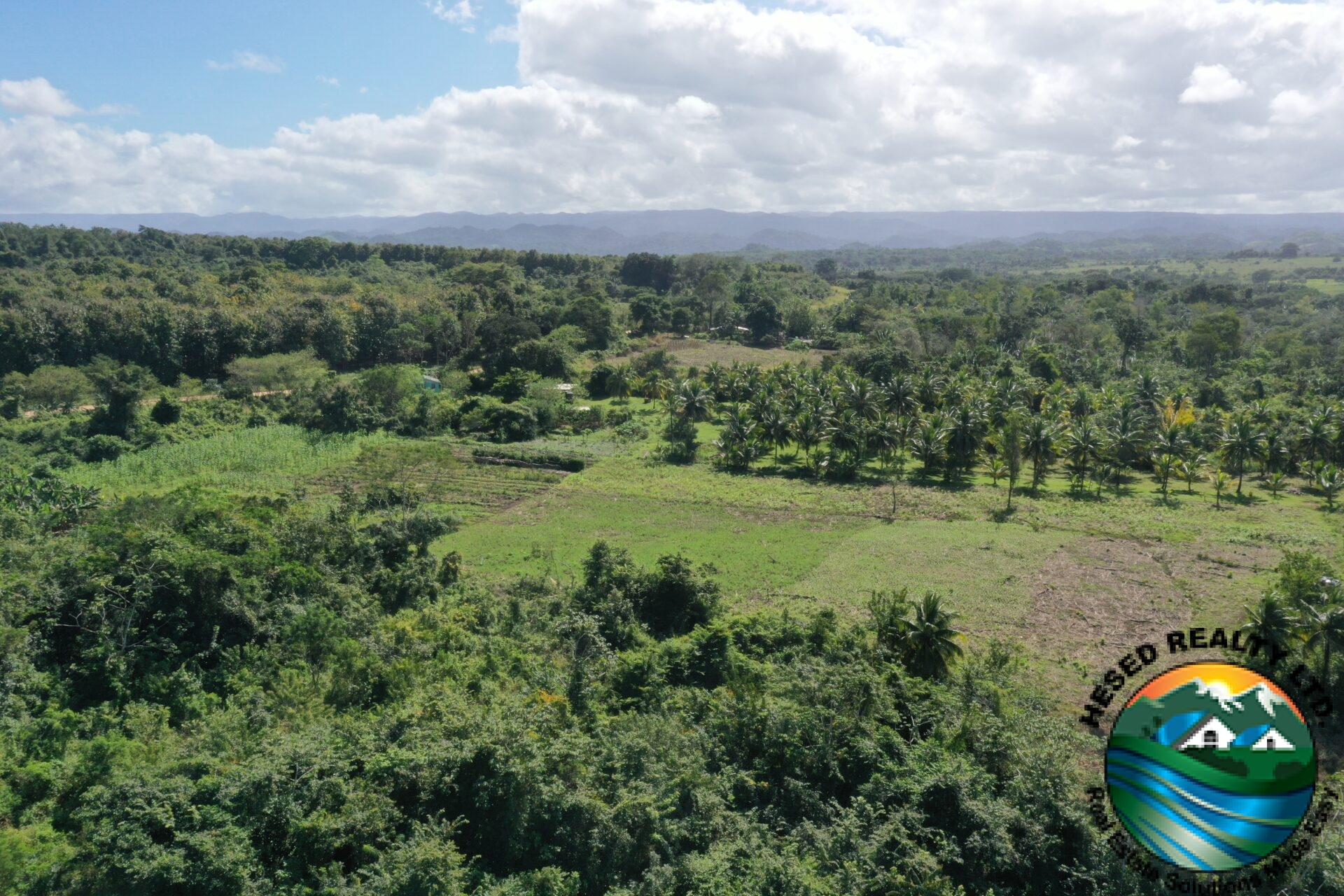 Drone photo showcasing a scenic view of the 30-acre Teakettle property surrounded by lush greenery.